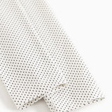 Leggings with elastic edge and fine polka dot pattern, white with black dots.