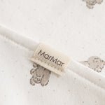 Plush teddy bear print and text label at the collar.
