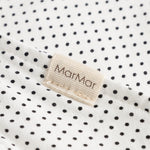 MarMar sweater in white with small black dots, triangular edge and beige label.