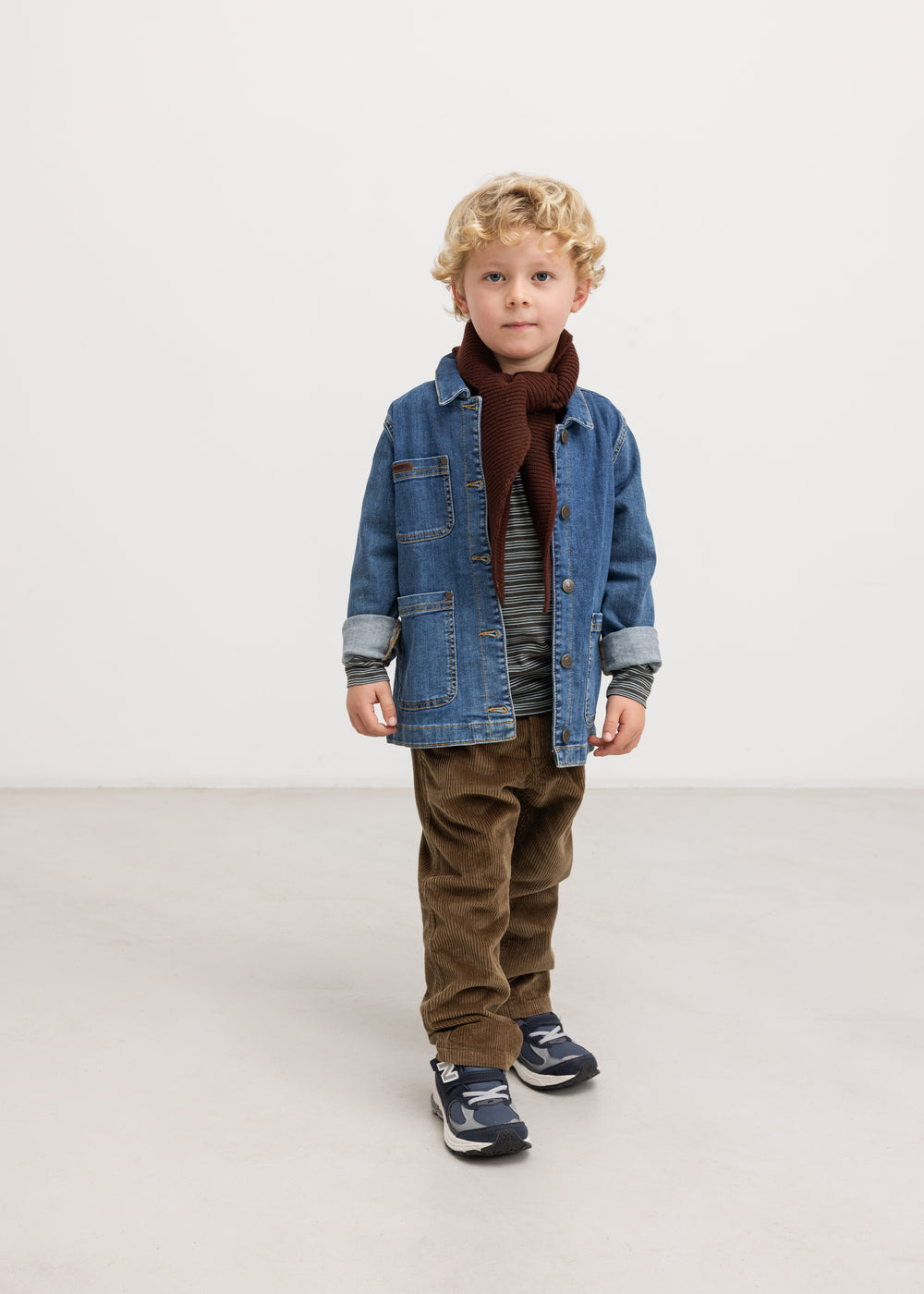 Dark wine-red scarf for child, worn under a blue denim jacket.