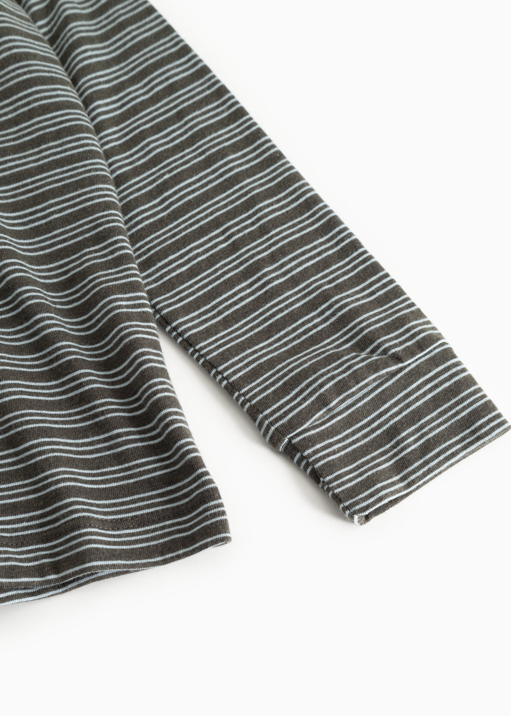 Details: dark gray striped blouse with long sleeves and thin light stripes.