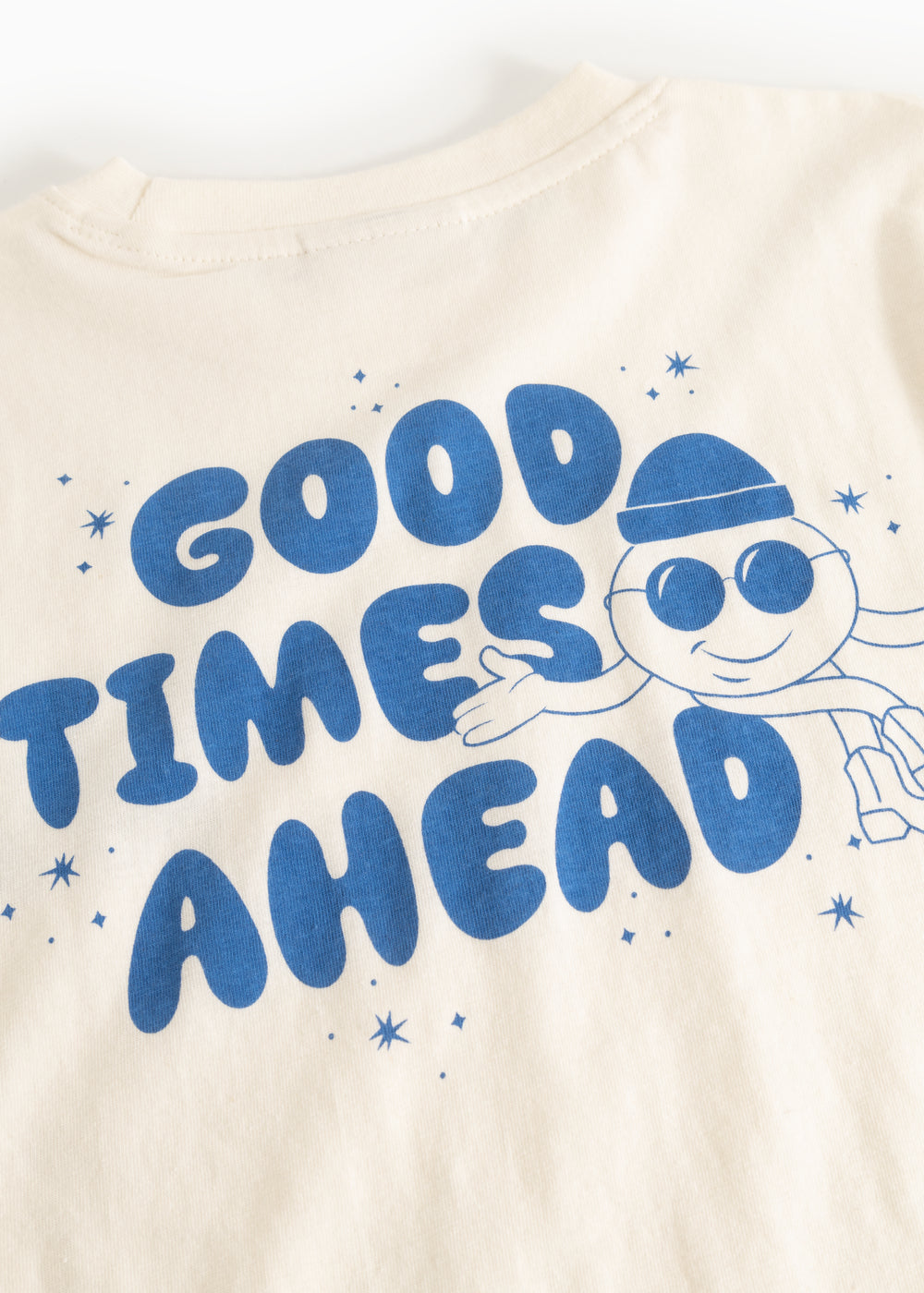 Long-sleeve blouse in cream with a large blue “Good Times Ahead” print.