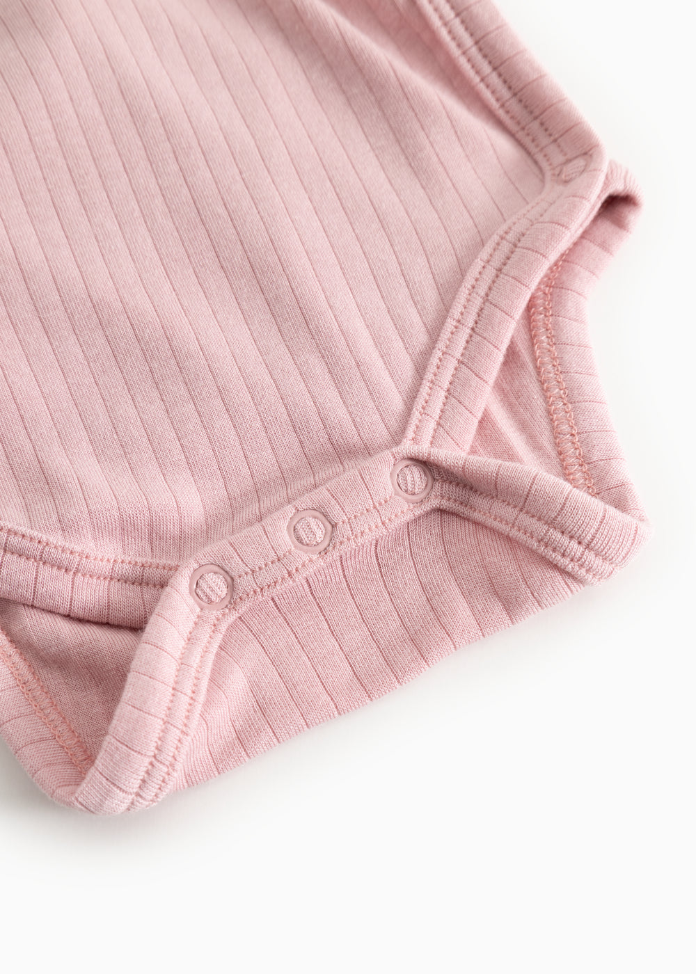 Pink ribbed bodystocking with snap buttons in the crotch and a hem at the sleeve.