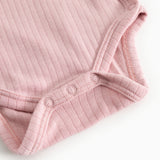 Pink ribbed bodystocking with snap buttons in the crotch and a hem at the sleeve.