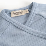 Light blue ribbed long-sleeve blouse with a wrap neckline and brand.
