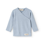 Light blue long-sleeve wrap blouse with V-neck and button closure