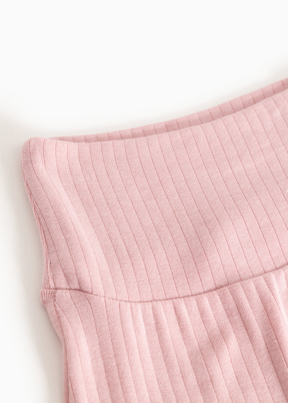 Pink baby pants: ribbed lining and a gentle wave pattern drape at the waist.