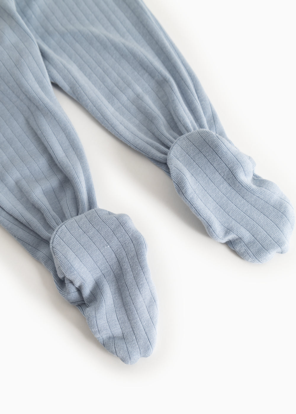 Light blue baby pants in rib knit with elastic at the ankles.