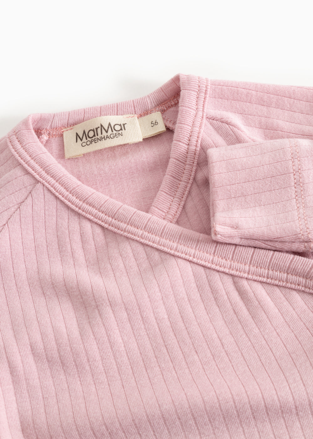 Pink jumpsuit with ribbed collar and label at the neckline.
