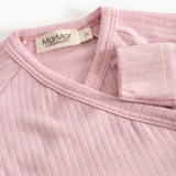 Pink jumpsuit with ribbed collar and label at the neckline.