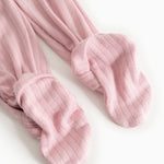 Pink baby onesie with ribbed cuffs at the ankles.