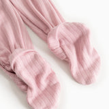 Pink baby onesie with ribbed cuffs at the ankles.
