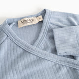 Light blue jumpsuit with V-neck and ribbed trim; logo label at the neck.