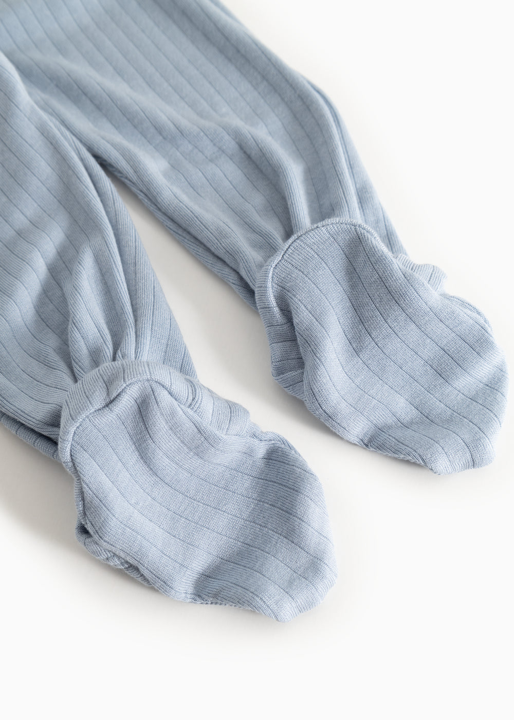 Light blue jumpsuit with ribbed texture and leg/arm cuffs.