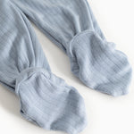 Light blue jumpsuit with ribbed texture and leg/arm cuffs.