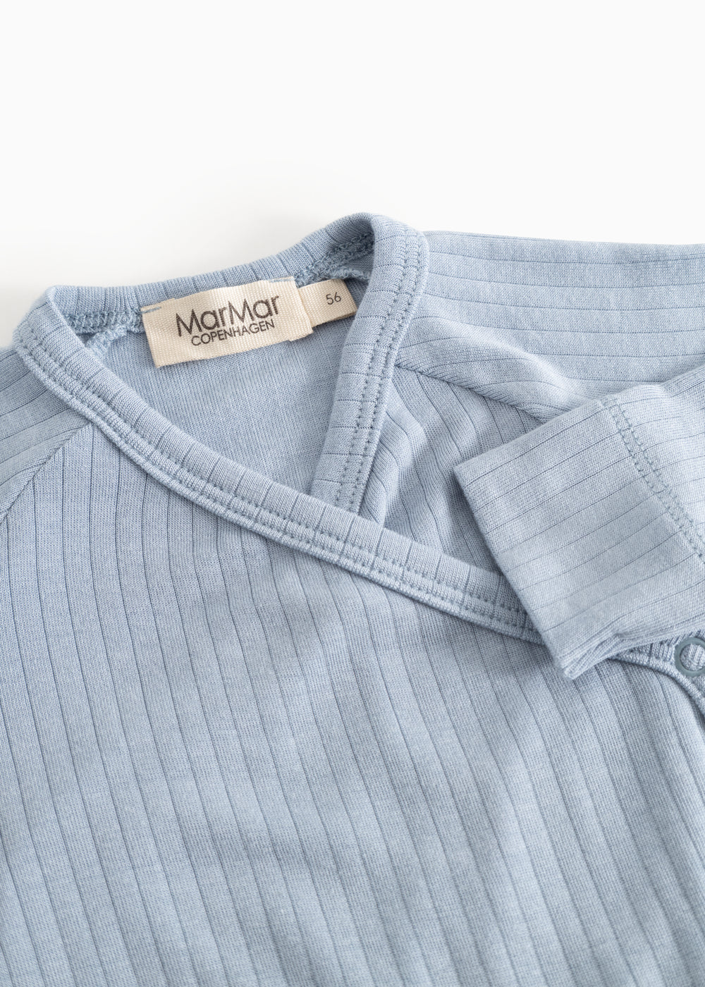 Light blue jumpsuit with high collar, rib stripes, and shoulder straps.
