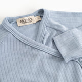 Light blue jumpsuit with high collar, rib stripes, and shoulder straps.