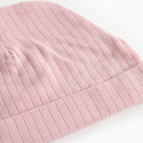 Pink ribbed baby hat with trim and visible stripes.