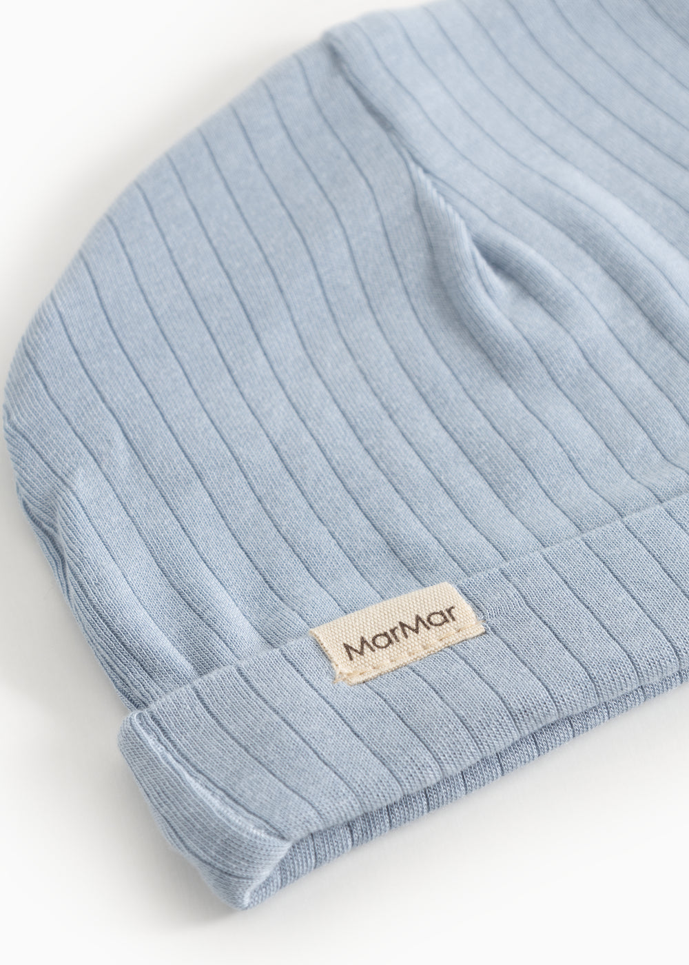 Blue ribbed stripe sweater with beige logo label on cuff.