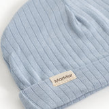 Blue ribbed stripe sweater with beige logo label on cuff.