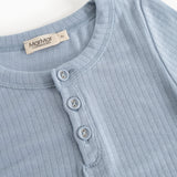 Light blue ribbed T‑shirt with a polo collar and three buttons at the neckline.