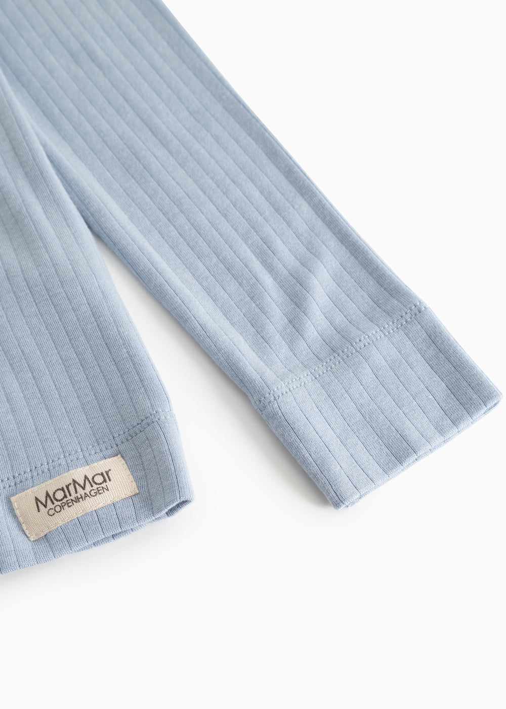Light blue ribbed long-sleeve T-shirt with button closure and brand label at the edge.