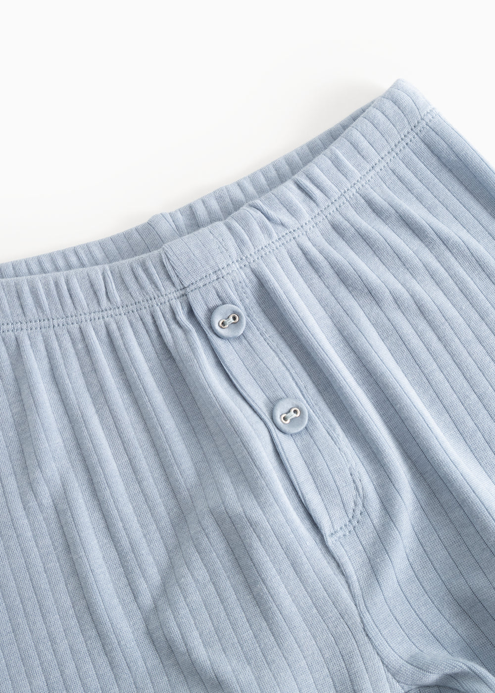 Light blue long leggings with elastic waistband and two front buttons.