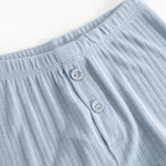 Light blue long leggings with elastic waistband and two front buttons.