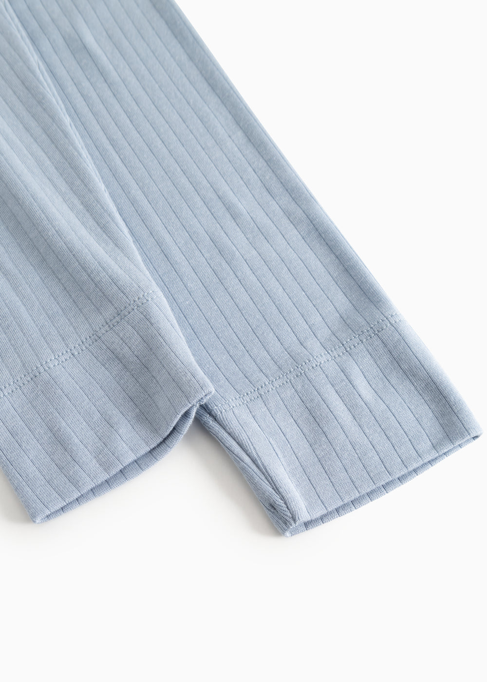 Light blue long leggings in ribbed texture, visible elastic at the leg opening.