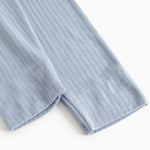Light blue long leggings in ribbed texture, visible elastic at the leg opening.