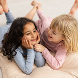 Pink leggings for kids, ribbed fabric and elastic waistband visible under the leg.