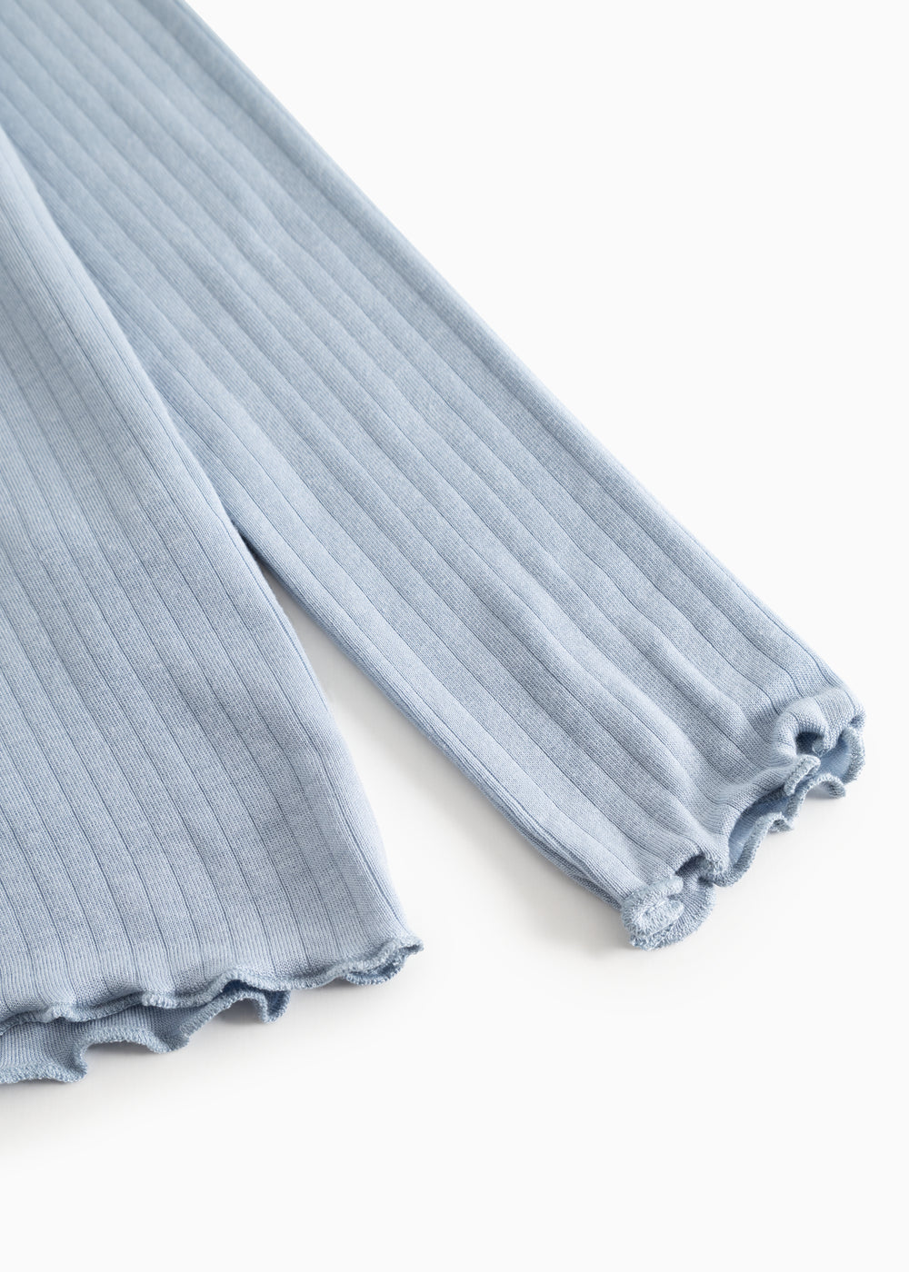 Light blue long-sleeve t‑shirt with ribbed fabric and crew neck, visible sleeve edge.