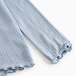 Light blue long-sleeve t‑shirt with ribbed fabric and crew neck, visible sleeve edge.