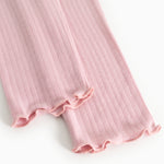 Pink leggings with ribbed knit and fringe edge at the ankle, elastic and lightweight drape.