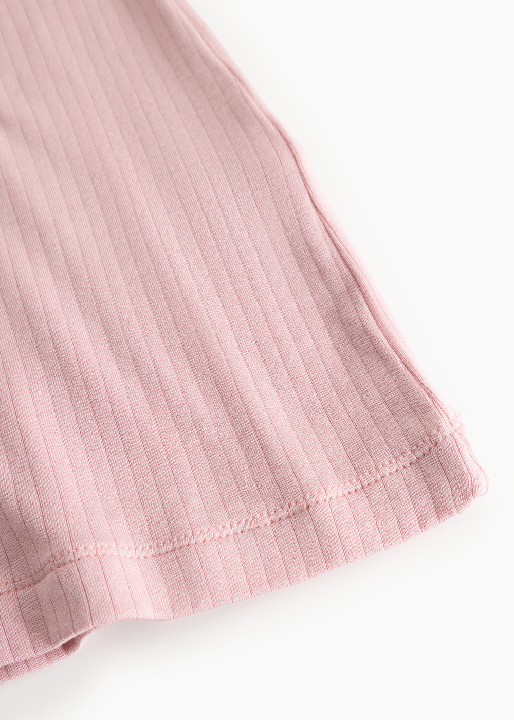 Pink evening dress: ribbed fabric and seam at the hem, visible edge finishing.