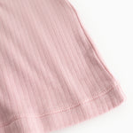 Pink evening dress: ribbed fabric and seam at the hem, visible edge finishing.