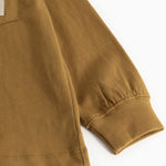 Caramel brown long-sleeve blouse with elastic cuffs and seam at the bottom.