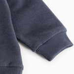 Blouse in dark navy with ribbed cuff at the sleeve.