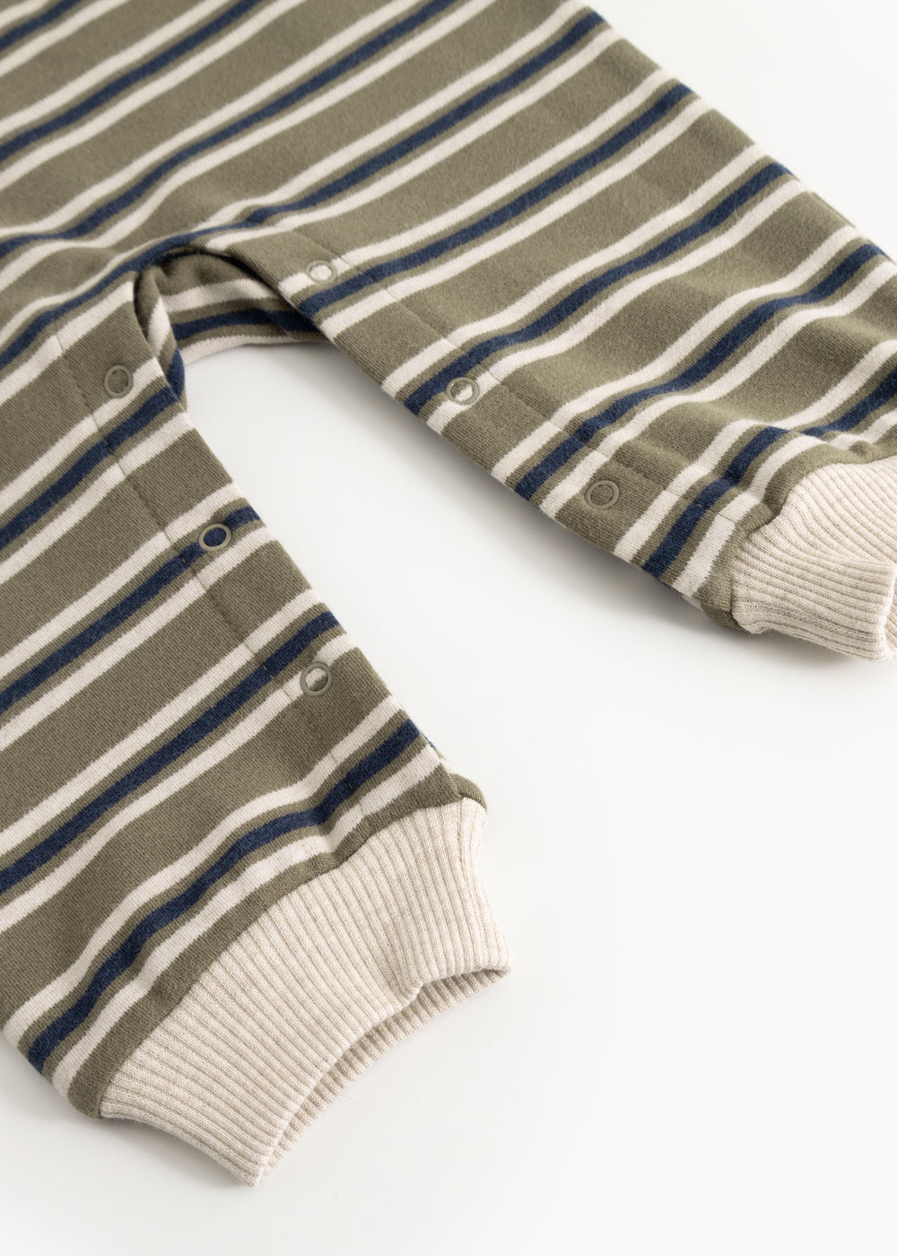 Striped fabric dress with frayed hem and sleeves and snap buttons at the neckline.