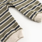Striped fabric dress with frayed hem and sleeves and snap buttons at the neckline.