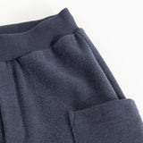 Blue denim kids' pants with a wide elastic waistband and cargo pockets.