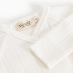 Baby romper in cream white with MaMar logo on the collar.