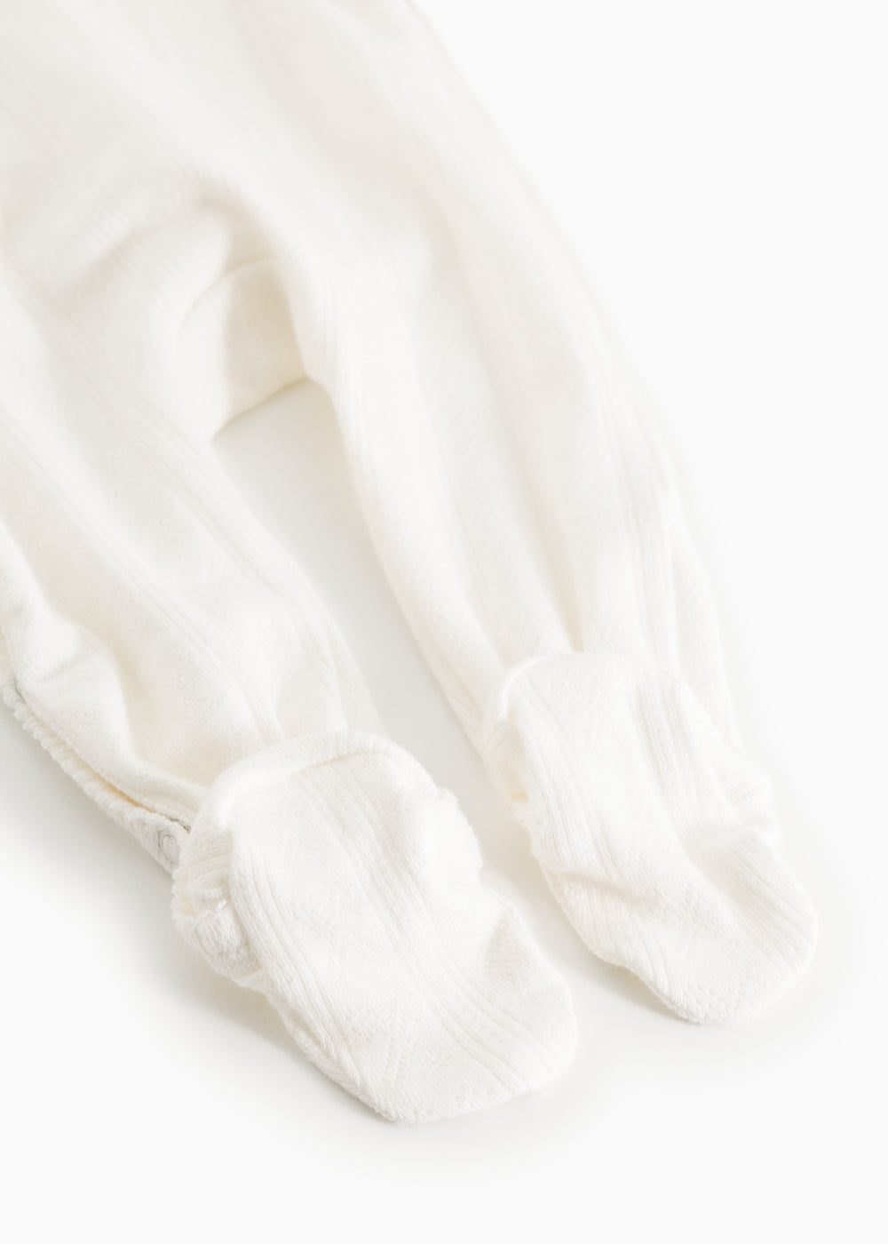 Baby romper in cream white with long legs and feet