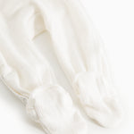 Baby romper in cream white with long legs and feet