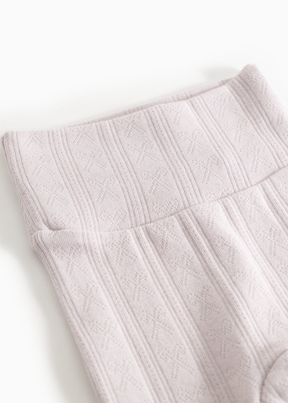 Baby pants with a close-up of a vertical pattern and elastic edge.