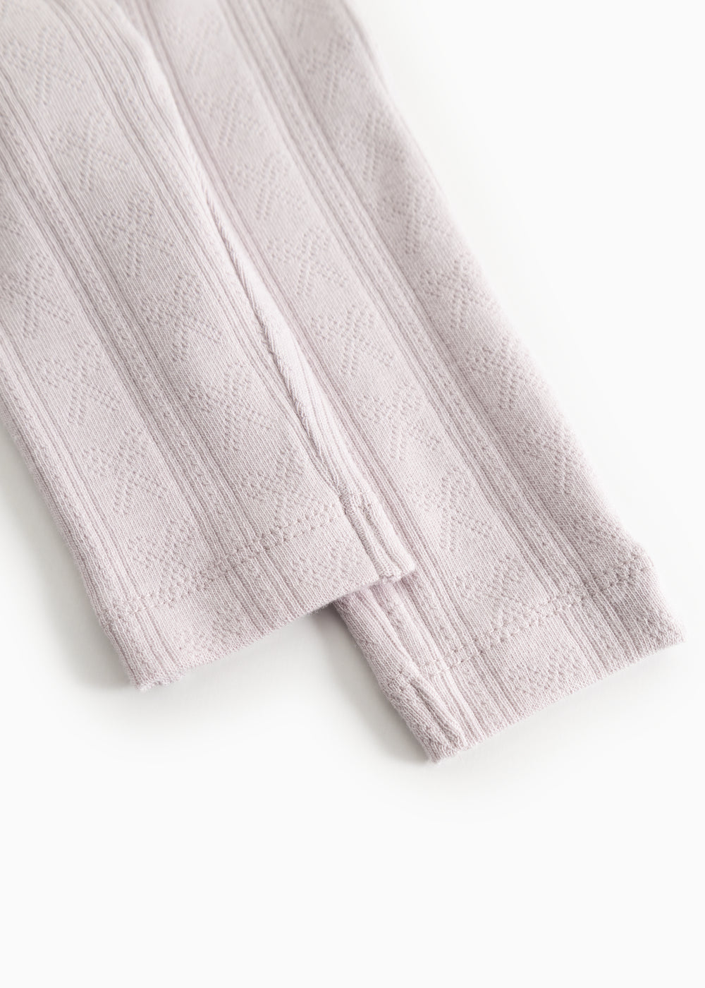 Baby pants in a light knitted texture with vertical stripes.