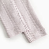 Baby pants in a light knitted texture with vertical stripes.