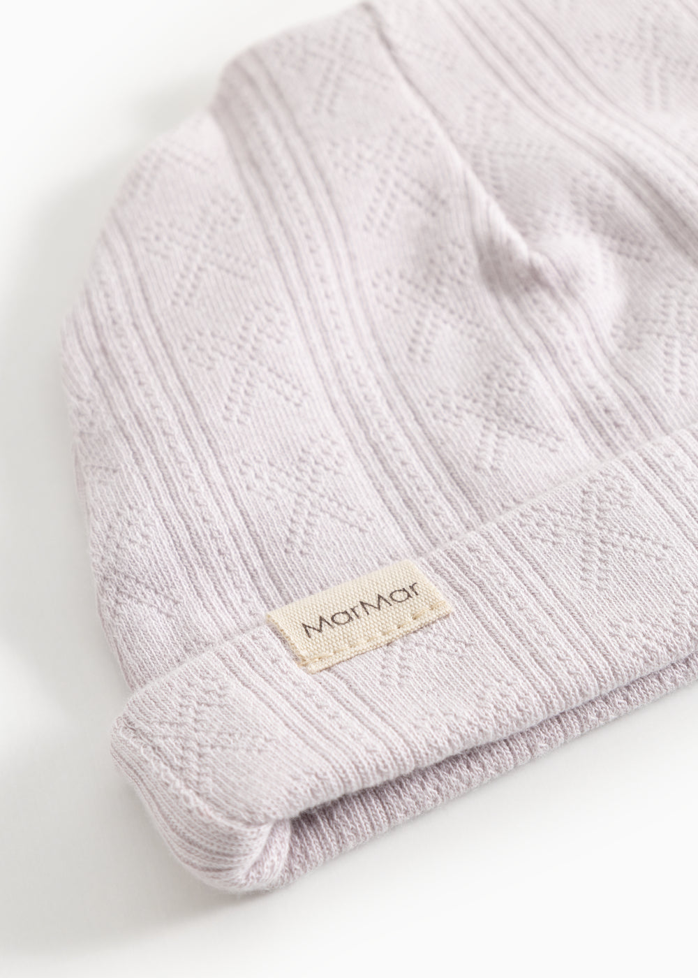 Aiko babyhue in light violet with diamond pattern and beige label on the edge