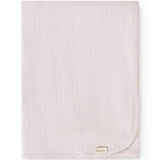 Bright little rug with woven pattern, smooth edge and small tag in the lower corner.
