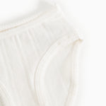White baby onesies with wide elastic and subtle rib pattern in front.